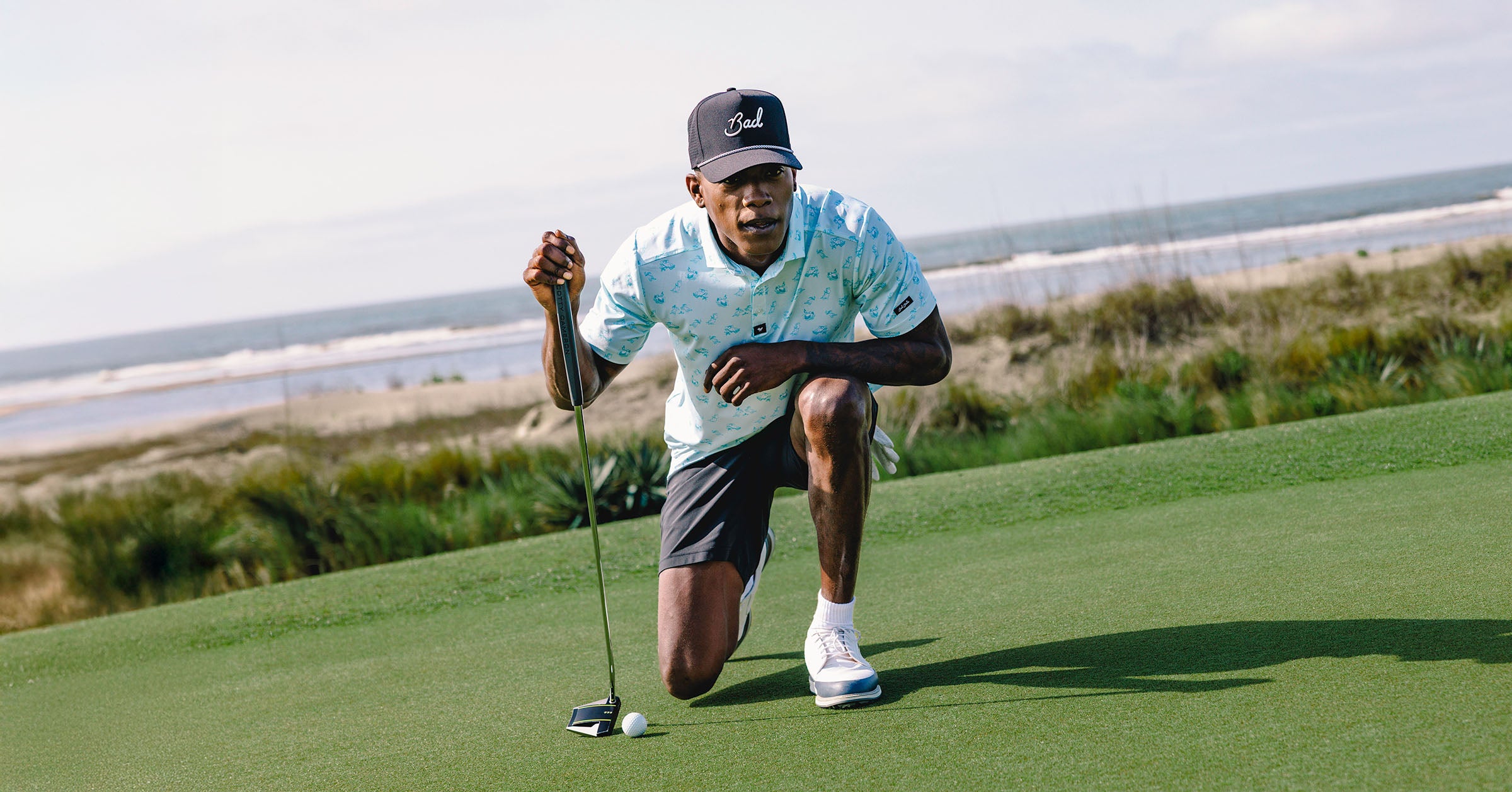 Golfer on a green with ocean view